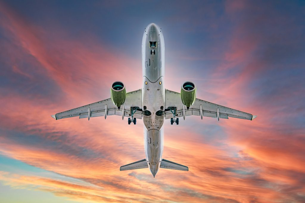 Commercial,Airplane,Jetliner,Flying,Above,Dramatic,Clouds,In,Beautiful,Sunset